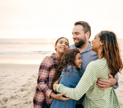 A-happy-family-standing-together A happy and relieved family hugging together after receiving cancer support