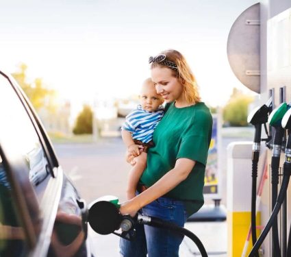 redkite-help-with-bills-fuel-food-childhood-cancer parent fuelling car with redkites financial assistance